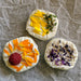 vegan almond goat cheese with edible flowers and herbs